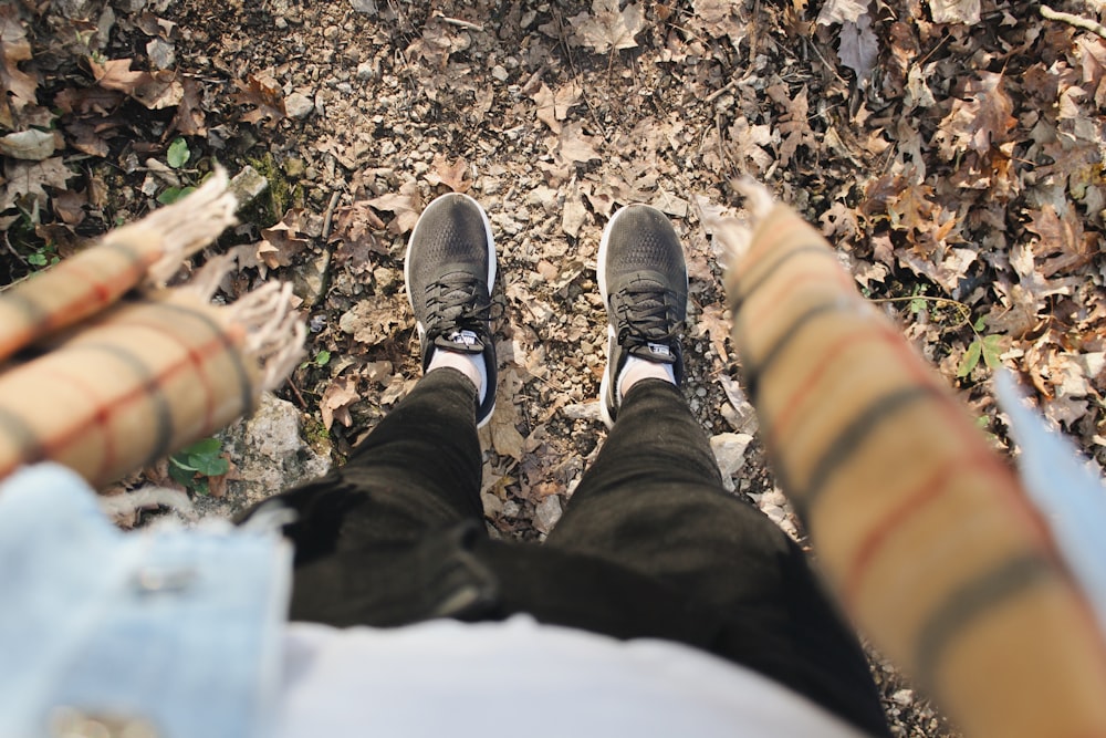 standing person wearing black pants and shoes