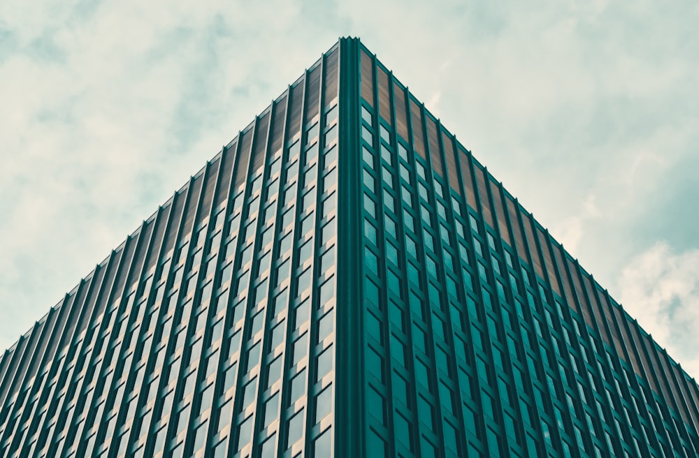 low-angle photography of blue high-rise building