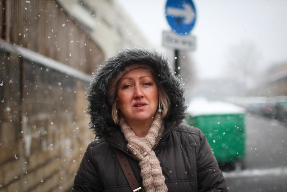 selective focus photography of gray coat at road snowing