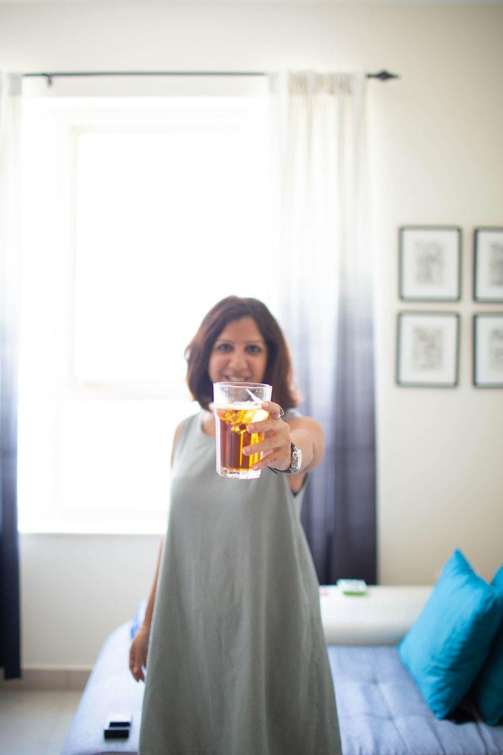 selective focus photography of standing woman holding out cup