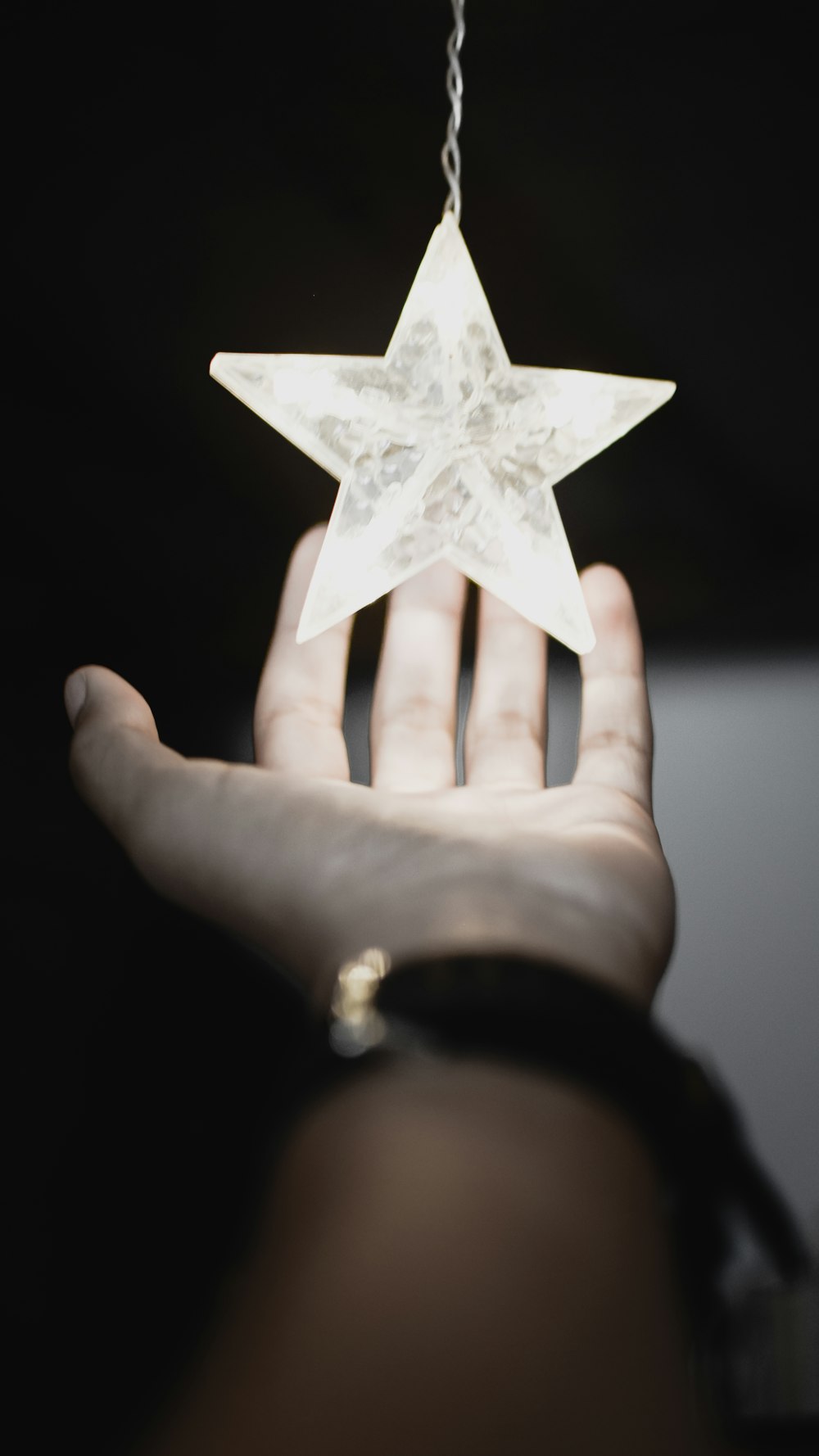 person touching LED light star