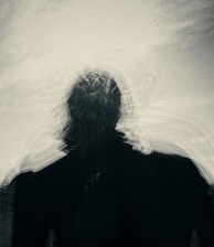 silhouette of person under gray sky