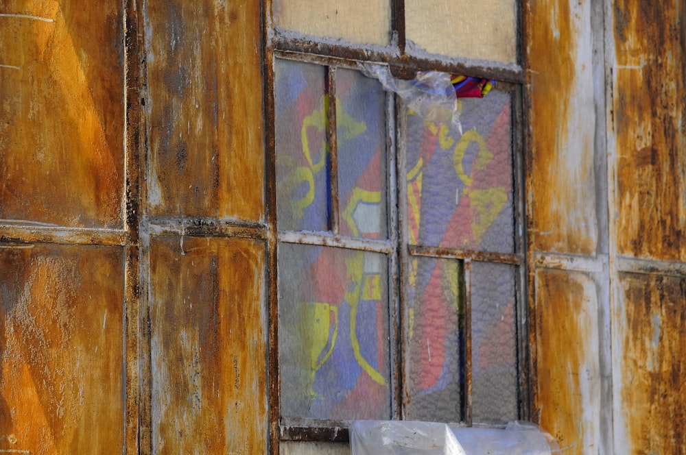 closed window with multicolored curtain