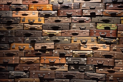 A collection of hardside luggage in various colors displayed together.