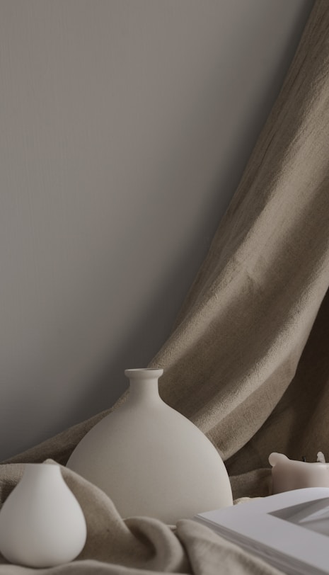 minimalist photography of two white ceramic vases