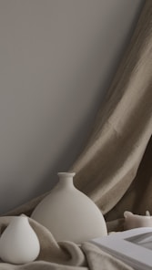 minimalist photography of two white ceramic vases