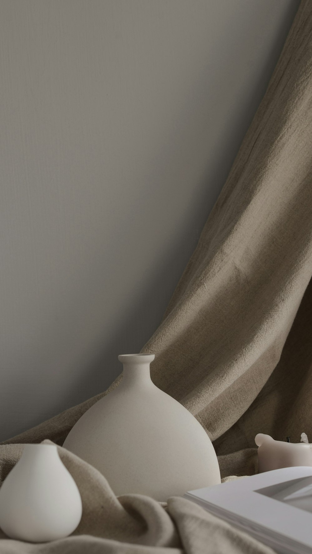 minimalist photography of two white ceramic vases