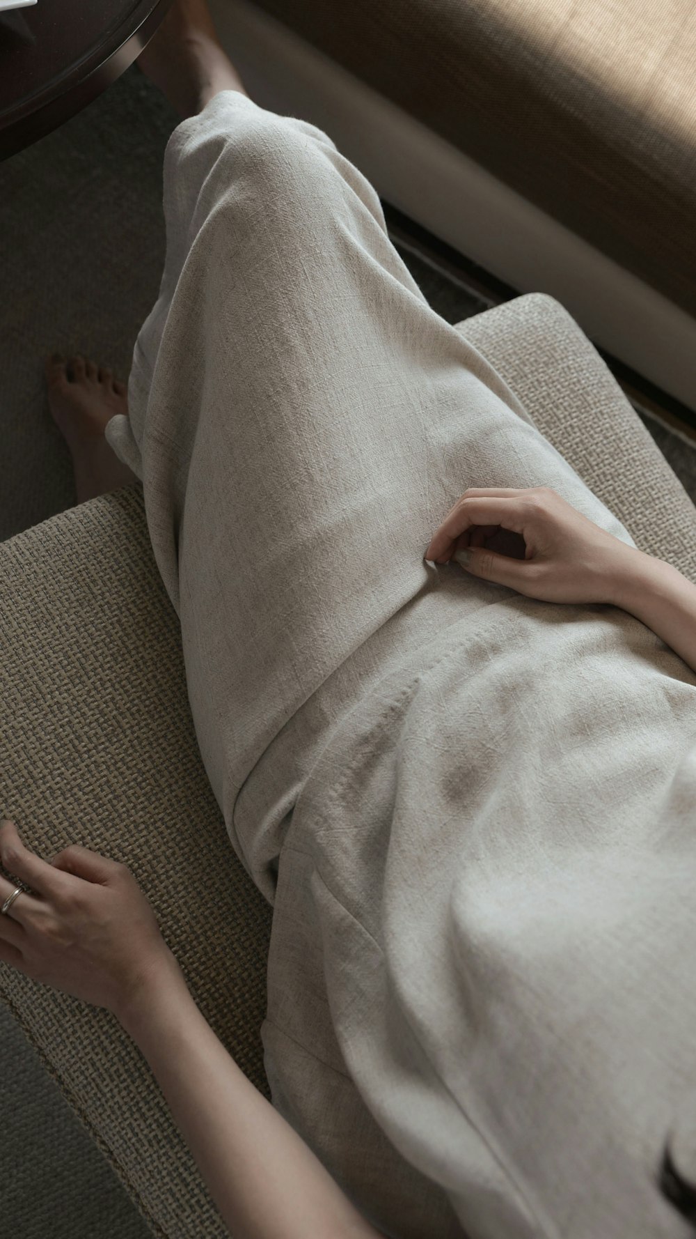 woman wearing white dress sitting sofa chair