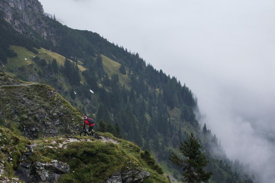 man riding on bicycle on top of mountain