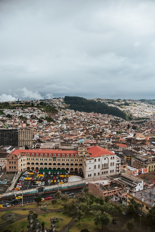 aerial photography of city under cloudy sky in Basilica del Voto Nacional Ecuador