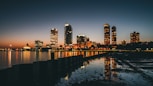 high-rise buildings near calm body of water