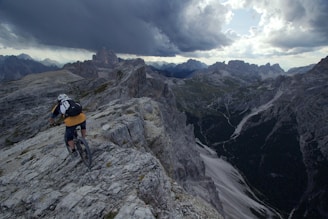 person wearing yellow shirt and black short riding on mountain bike