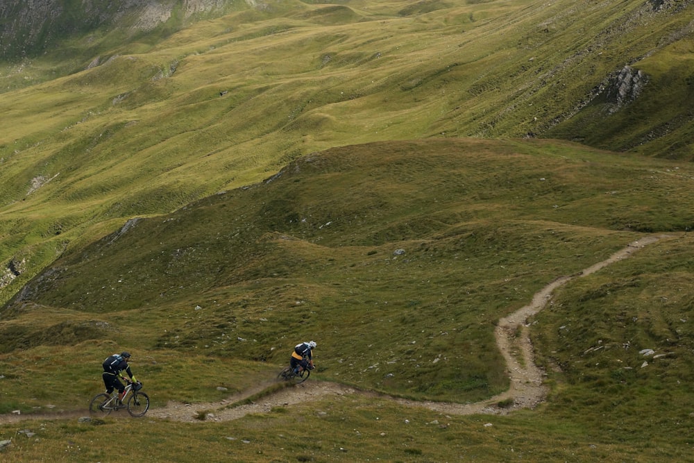 person riding mountain bike riding on mountain slope