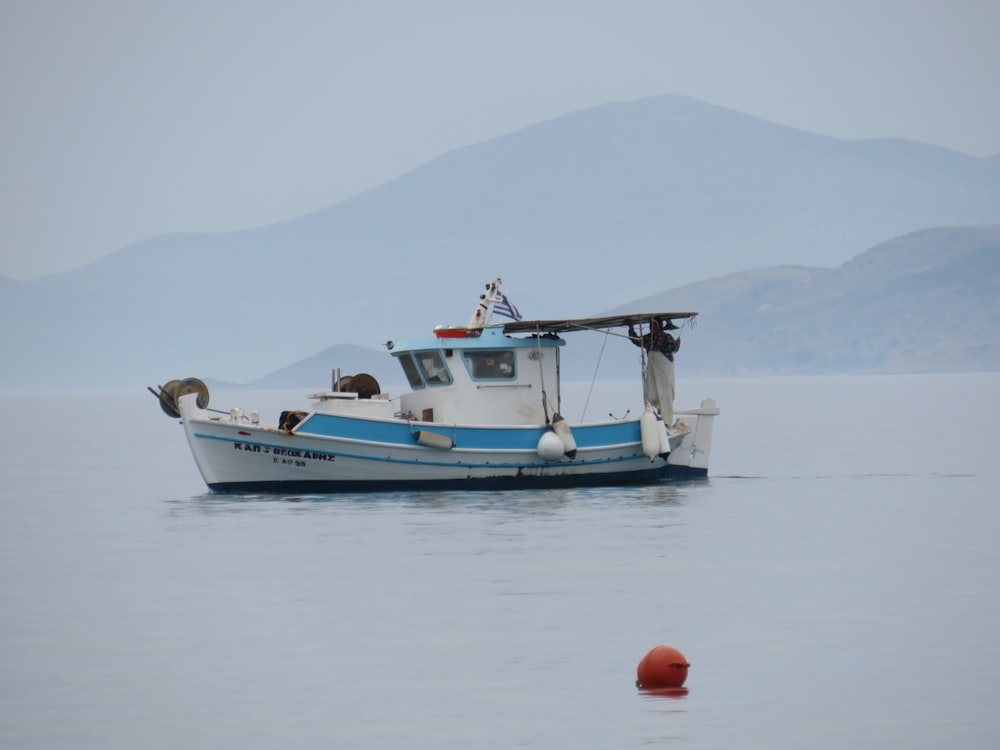 photo of white and blue sailboat