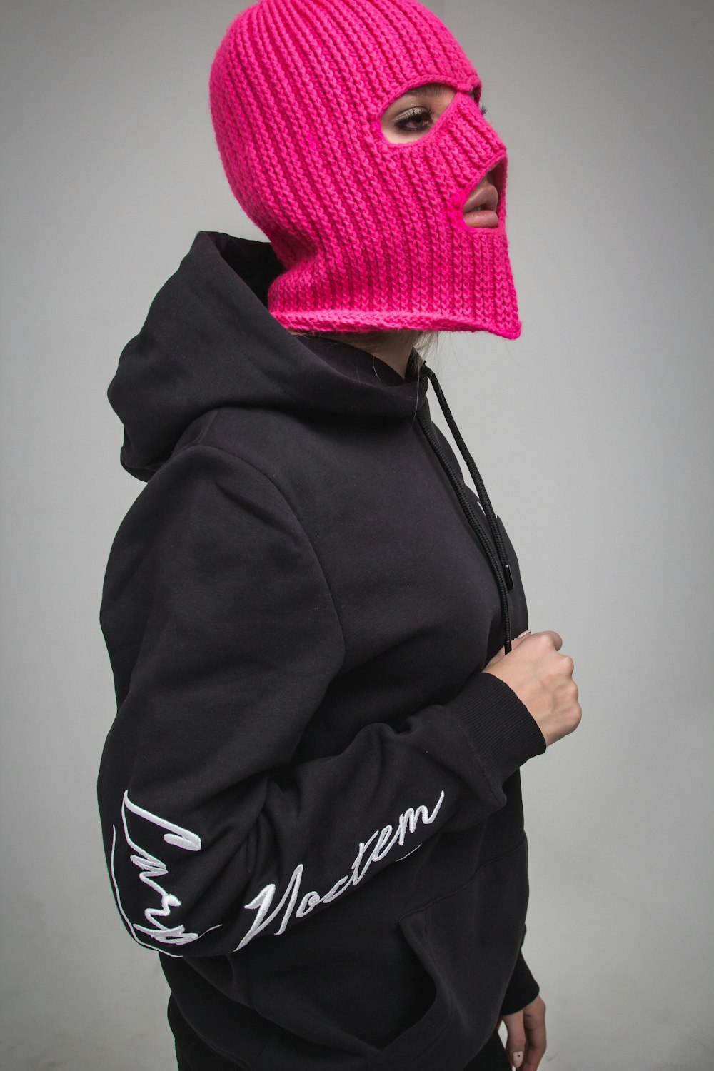 woman wearing pink knitted mask