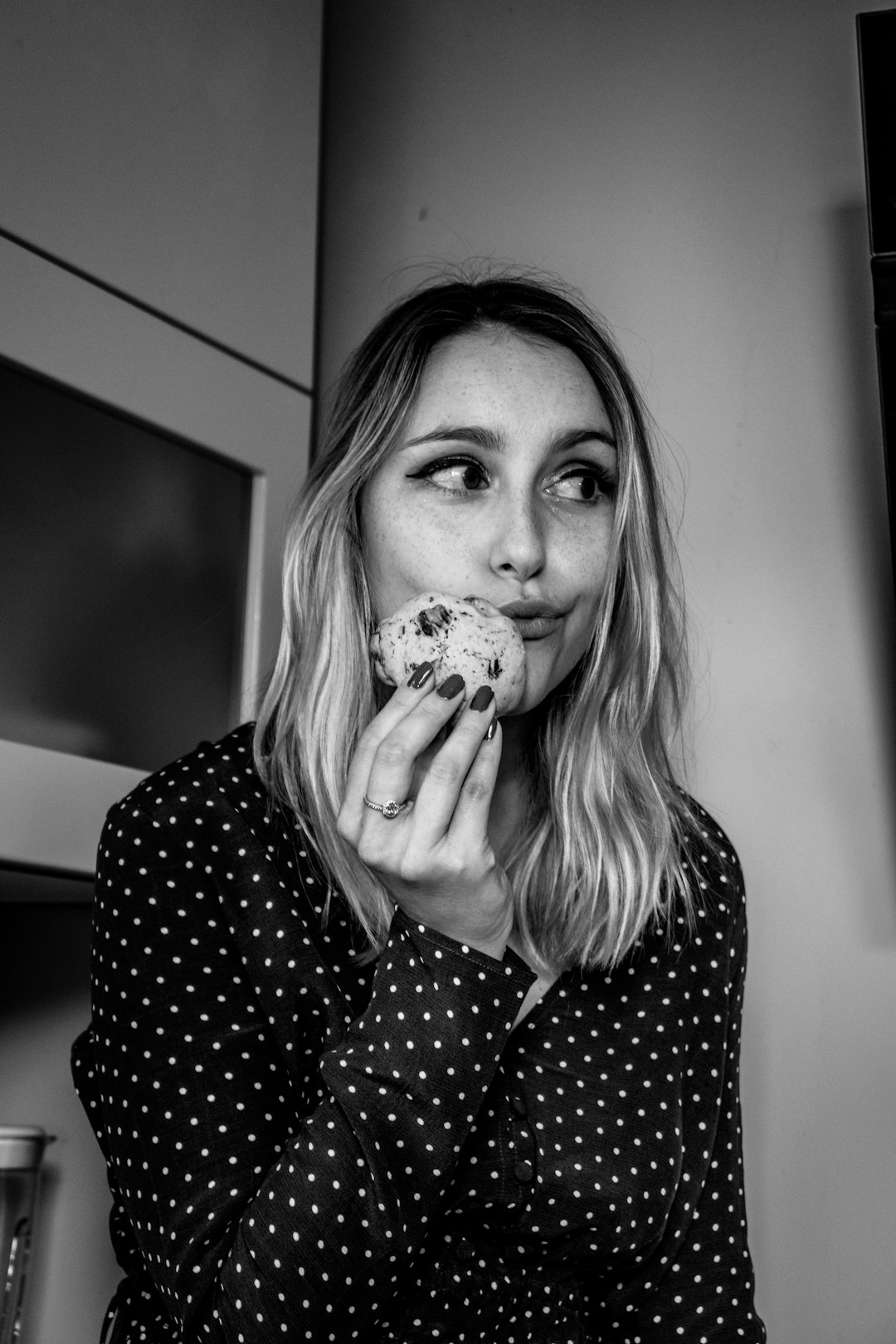 woman wearing black and white polka-dot long-sleeved shirt