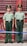 Two uniformed guards stand at attention in front of a weathered red door with metal bars. They are dressed in green military uniforms with matching hats featuring emblems.