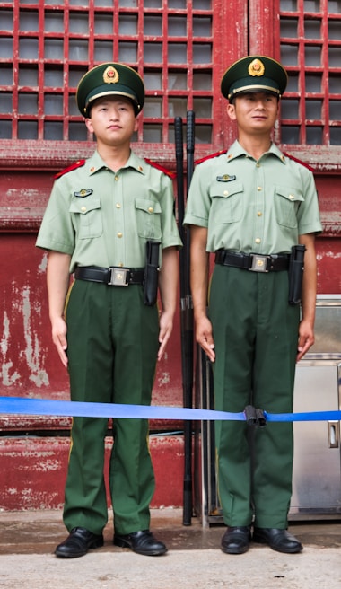 Security guards in uniform standing alert outside a commercial building in Delhi