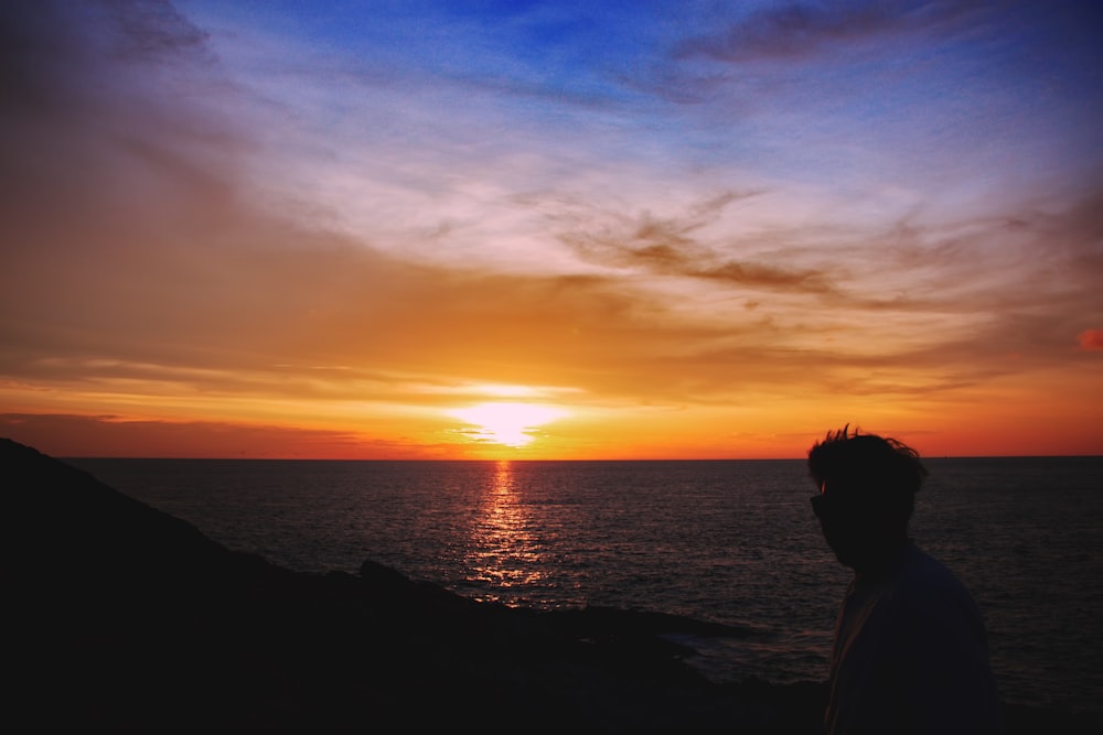 silhouette photography of man on shore