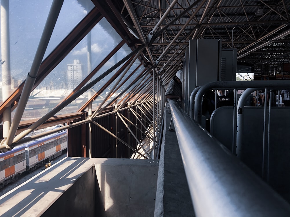 a train traveling through a train station next to a tall building