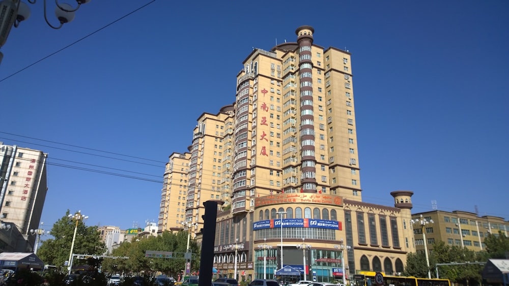 low-angle photography of beige concrete building under blue sky