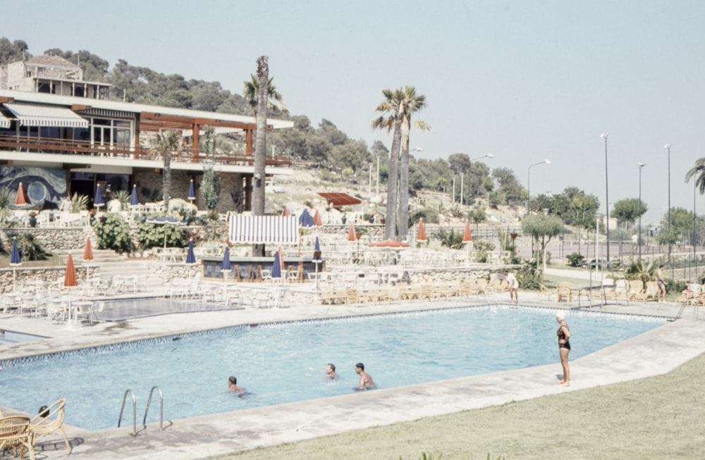 woman wearing black swimsuit standing on pool