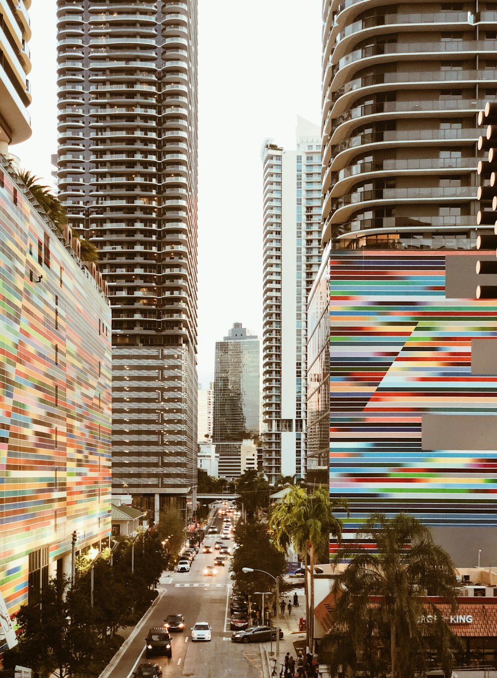 a city street with tall buildings in the background