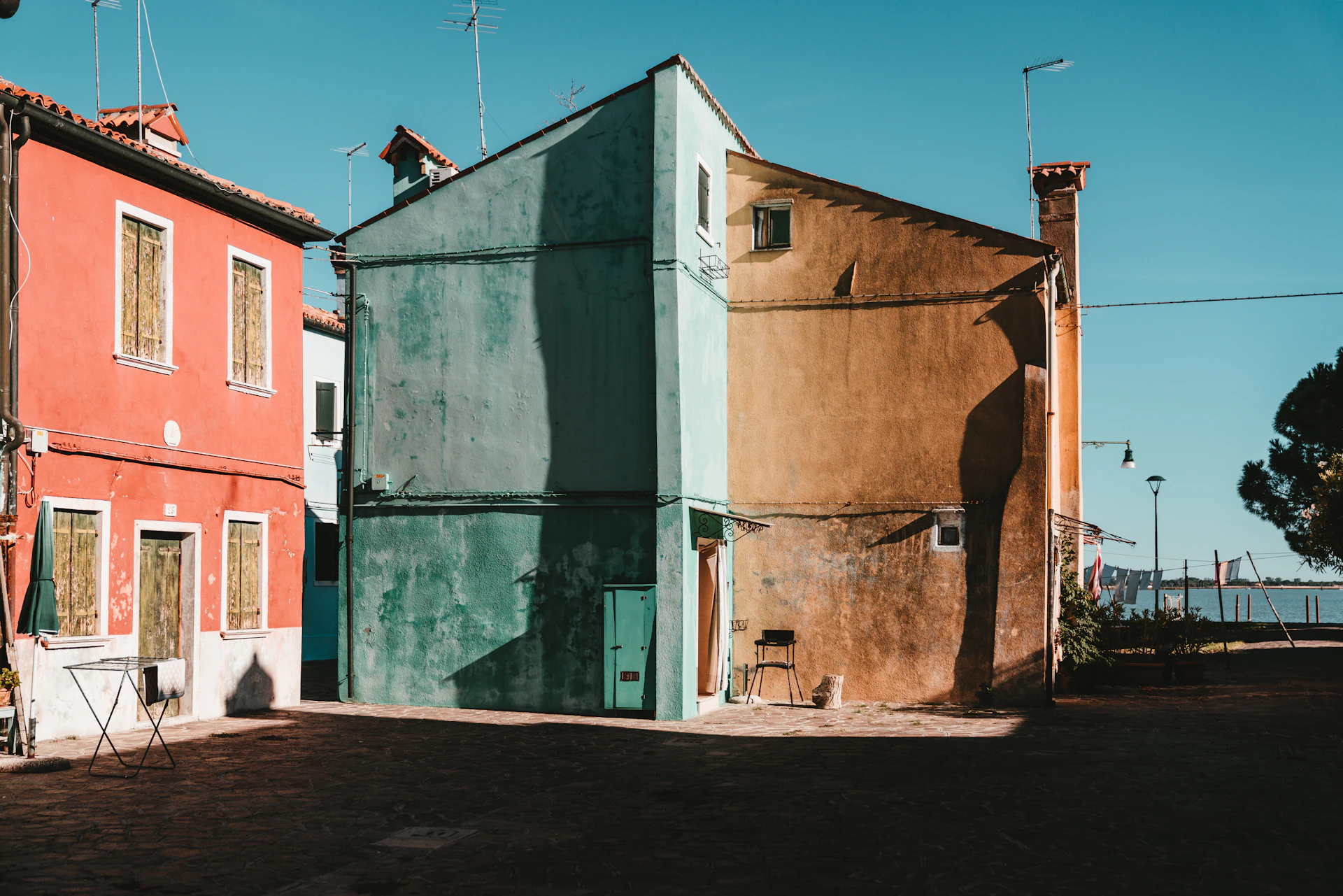 A charming street scene from Sassnitz on Rügen Island, with colorful houses and the Baltic Sea in the background.