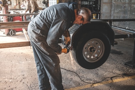 man fixing a vehicle tire