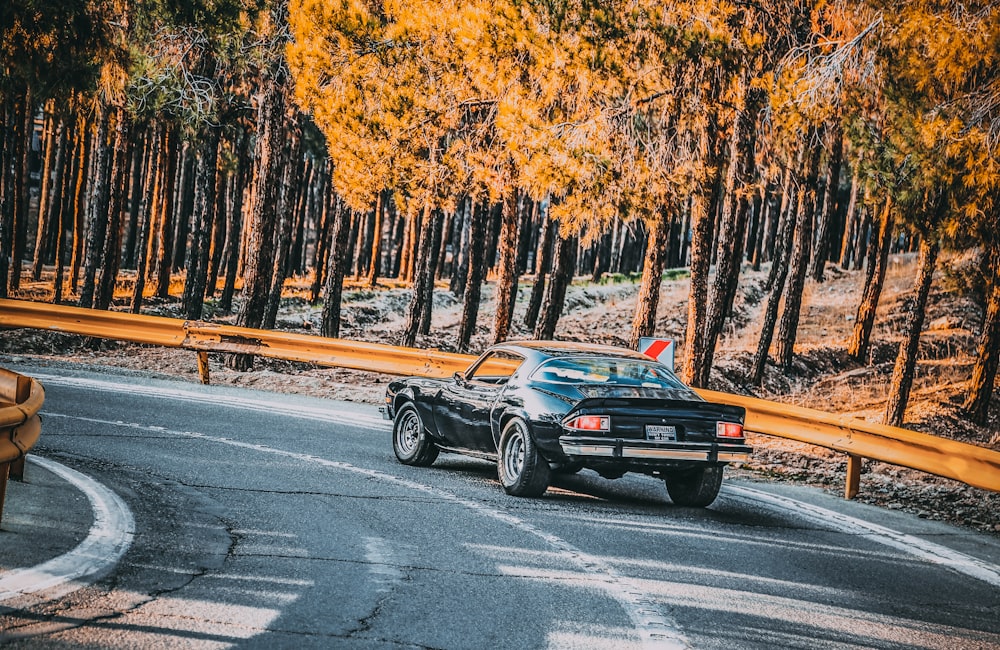 black coupe traveling on road