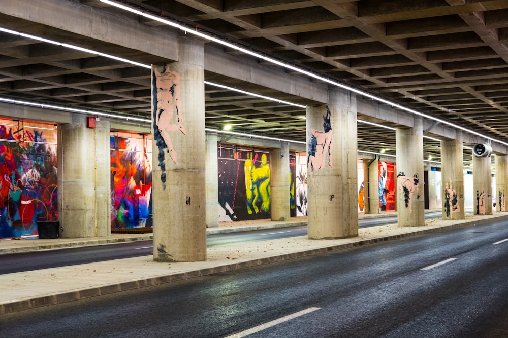 black top road under bridge