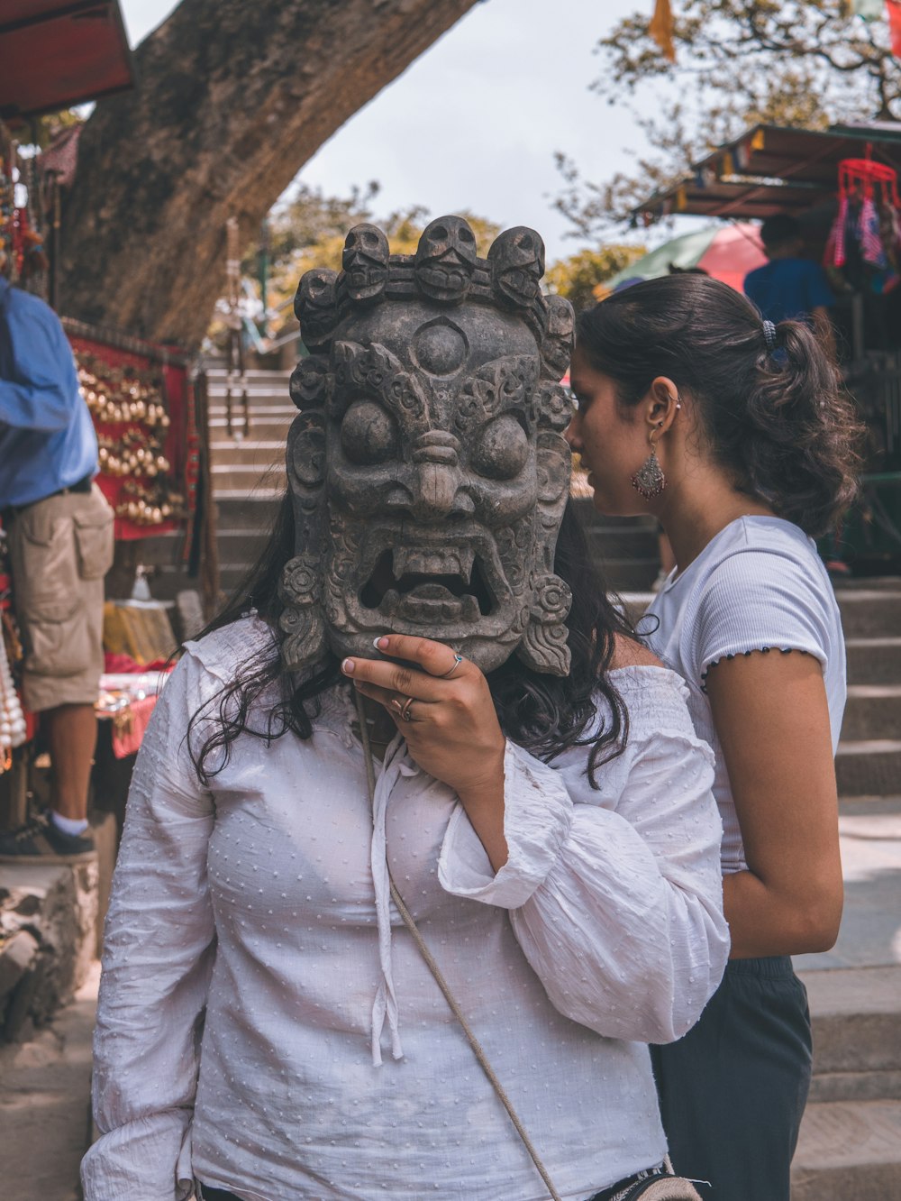 woman wearing a gray monster m ask