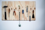 minimalist photography of hand tools hanged on wall