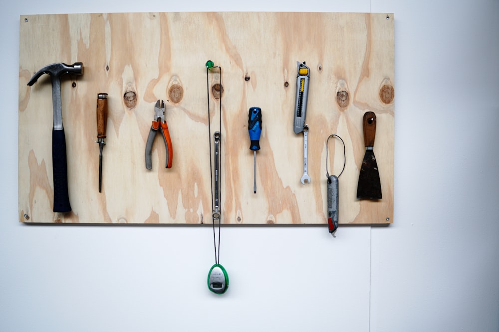 minimalist photography of hand tools hanged on wall