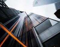 low-angle photo of high-rise buildings under white sky