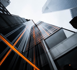 low-angle photo of high-rise buildings under white sky