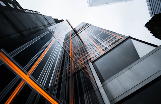 low-angle photo of high-rise buildings under white sky