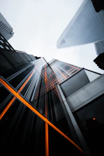 low-angle photo of high-rise buildings under white sky
