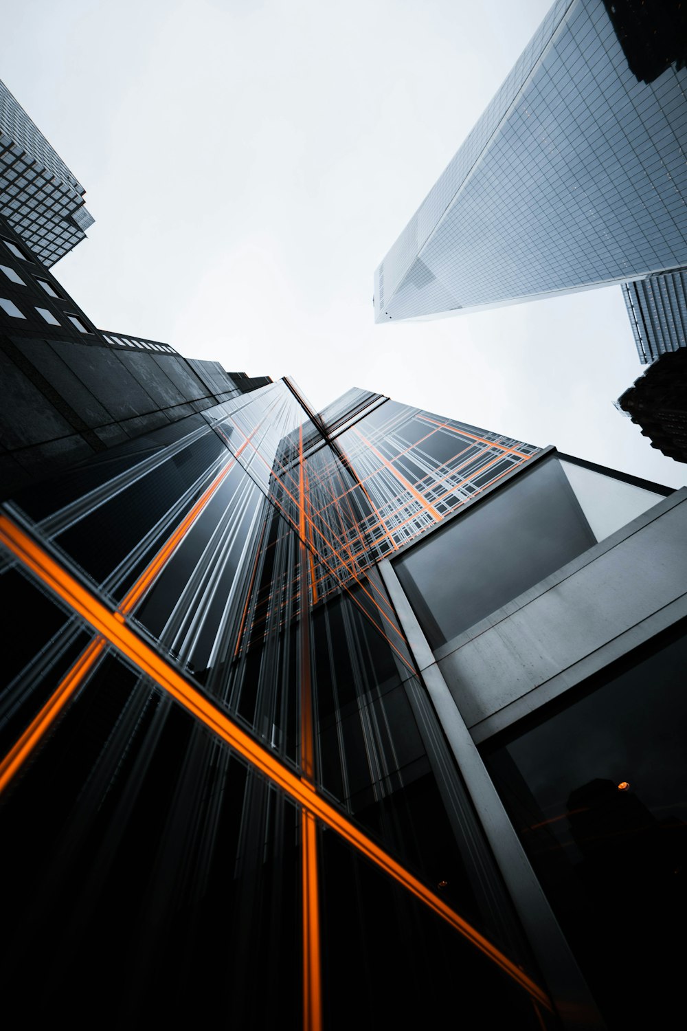 low-angle photo of high-rise buildings under white sky