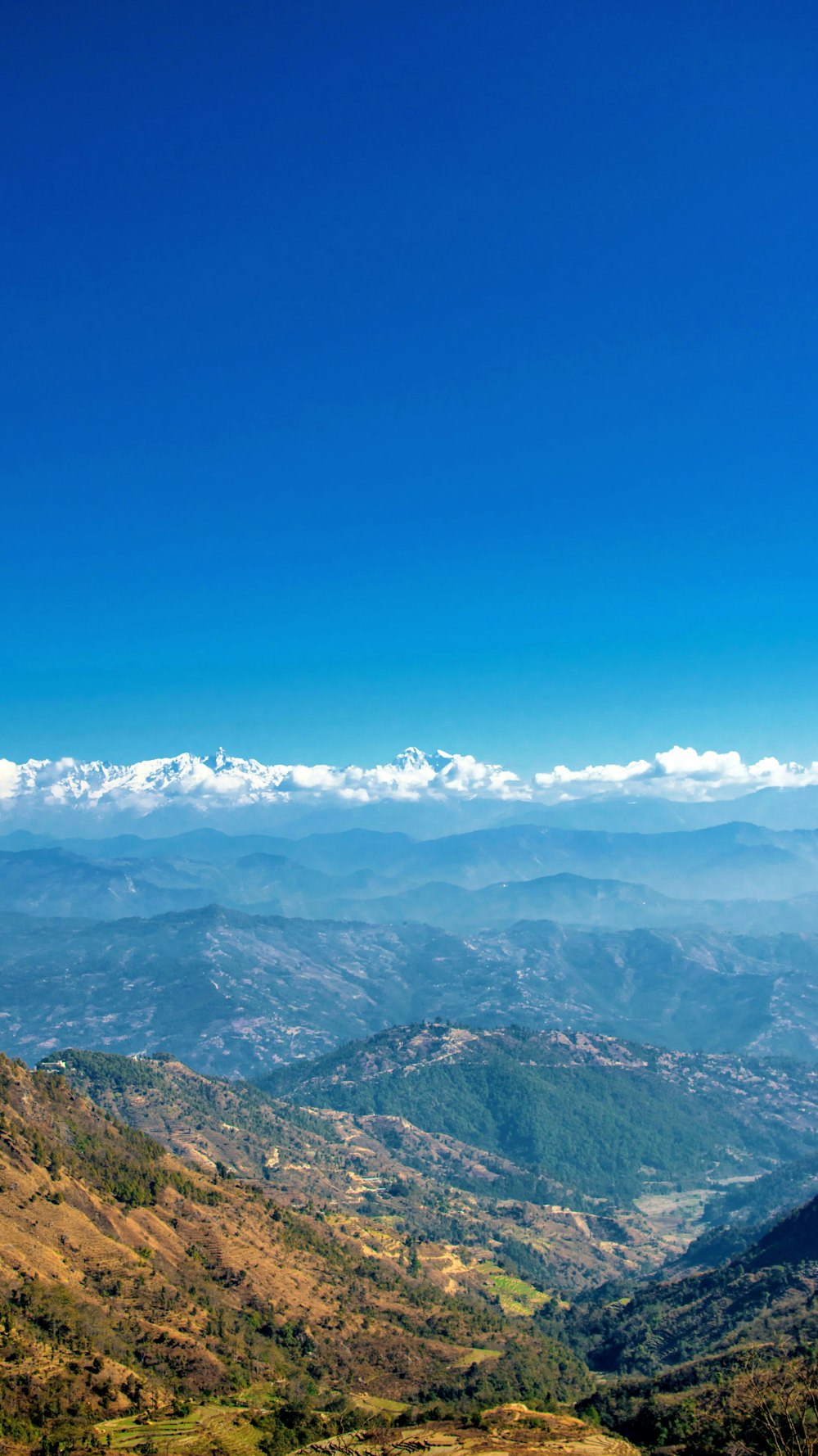 mountain ranges under blue clouds