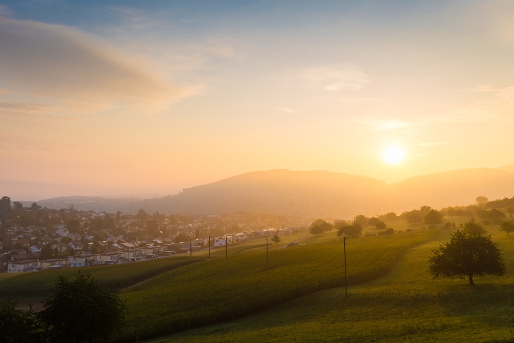 the sun is setting over a small town