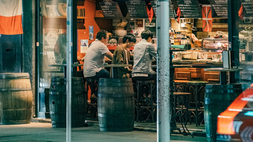 men sitting on barstools