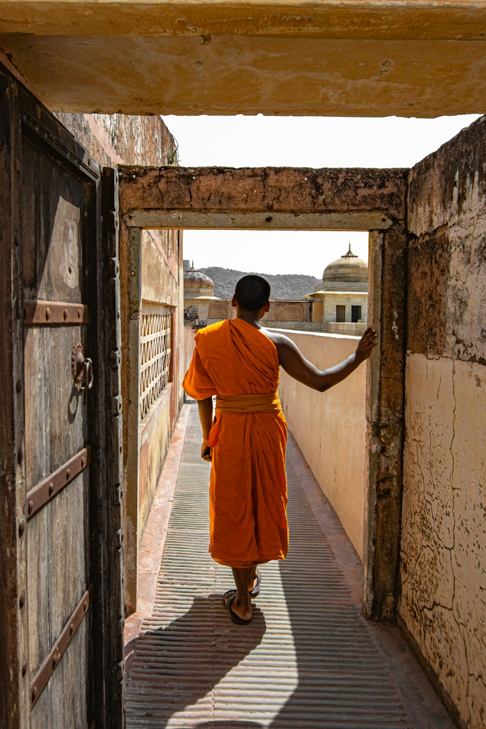 person in orange one-shoulder dress