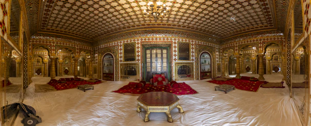 Luxurious traditional Saudi majlis with elegant gold and black accents.