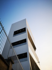 low-angle photo of white building under white sky