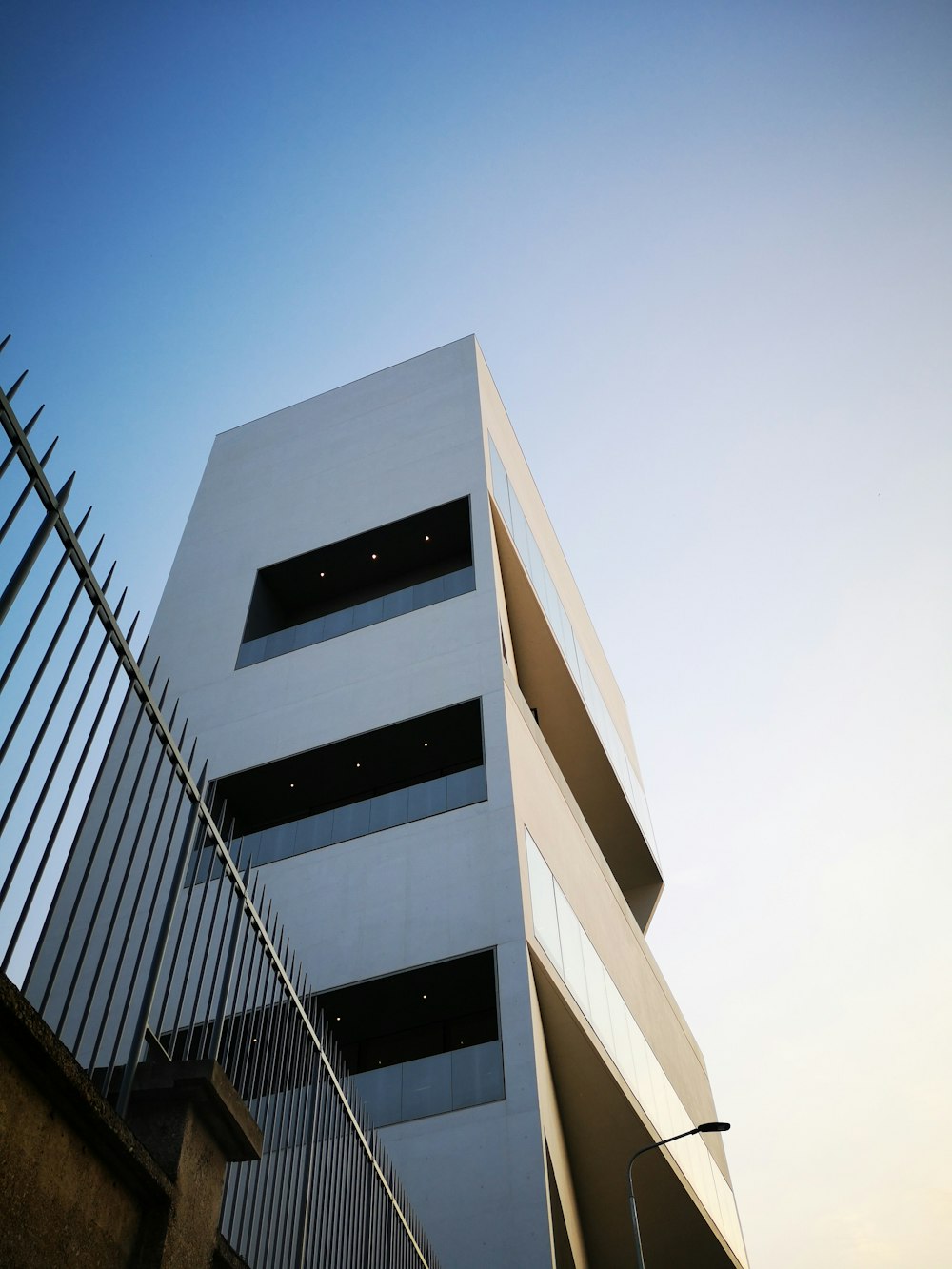 low-angle photo of white building under white sky