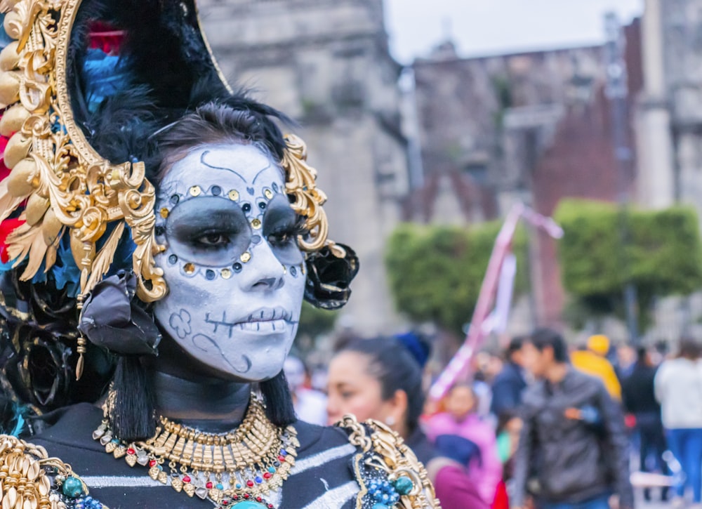 woman wearing gold-colored accessories and face paint