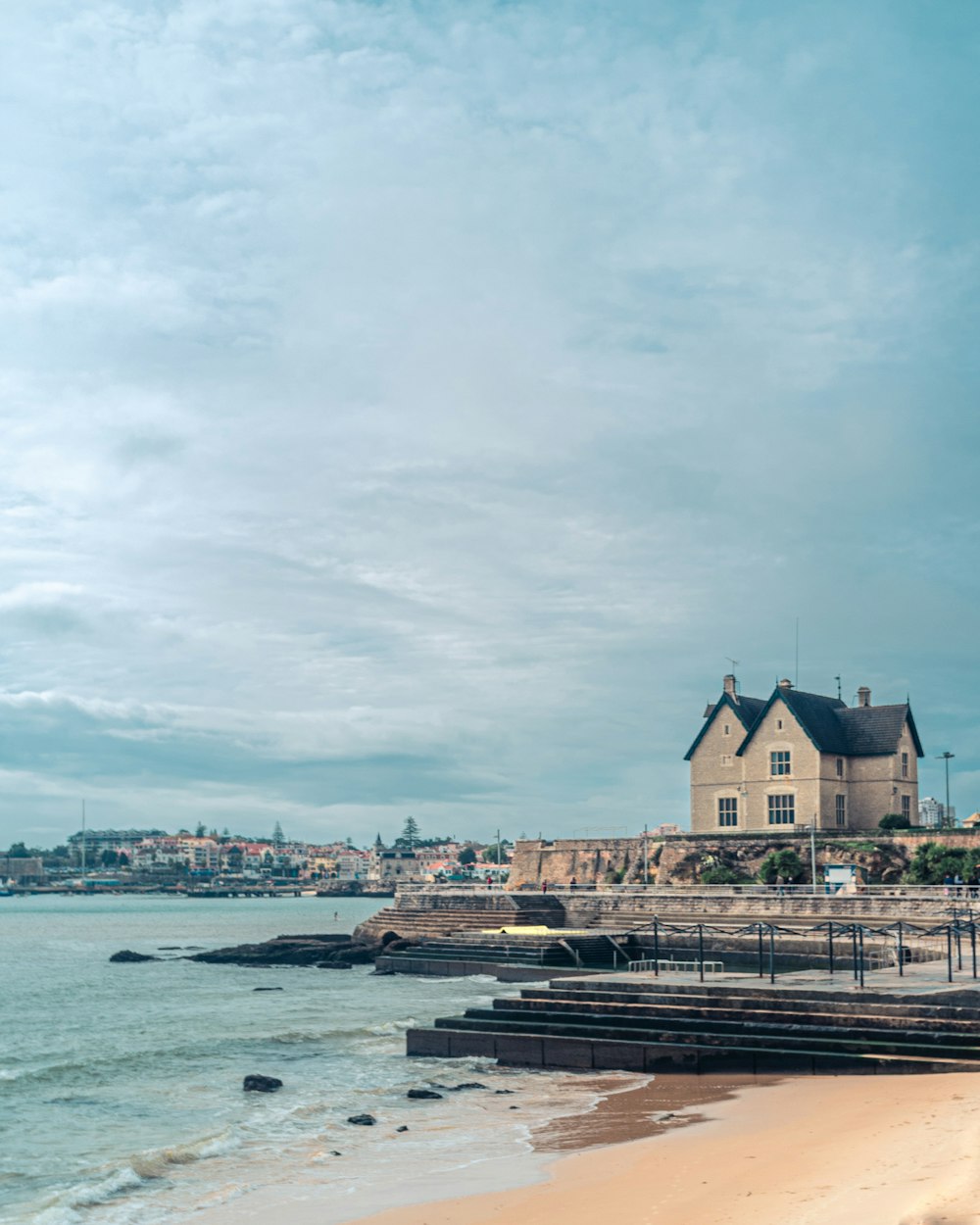 a house by the sea under a calm blue sky