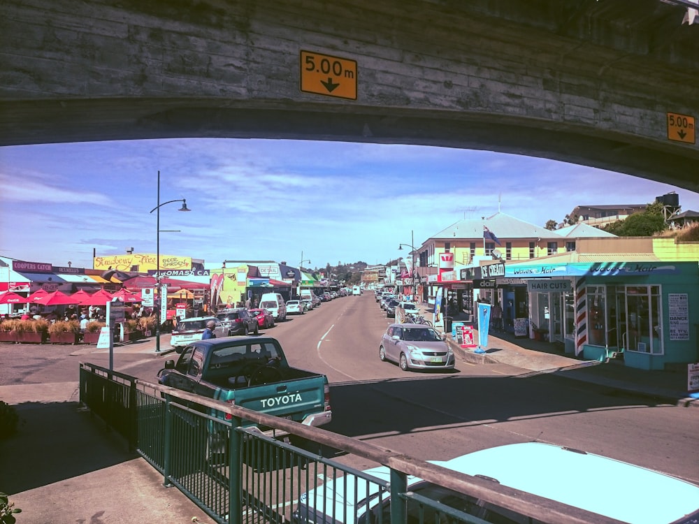 vehicles on road with overpass