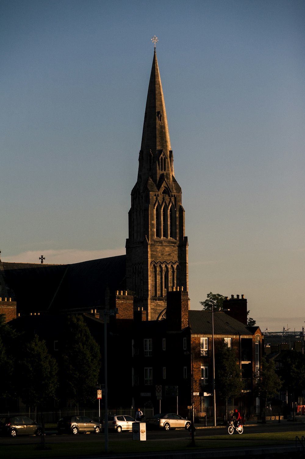 vehicles parking near brown castle under blue and white sky during daytime